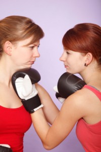 Two women boxing each other