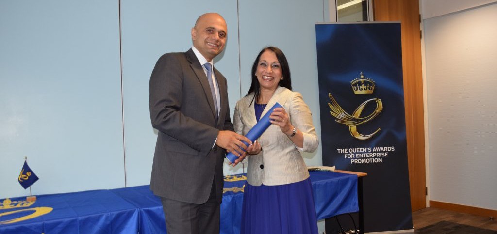 Secretary of State for Business, Innovation & Skills, The Right Hon Sajid Javid MP presents The Queen's Award for Enterprise Promotion scroll to Lopa Patel MBE